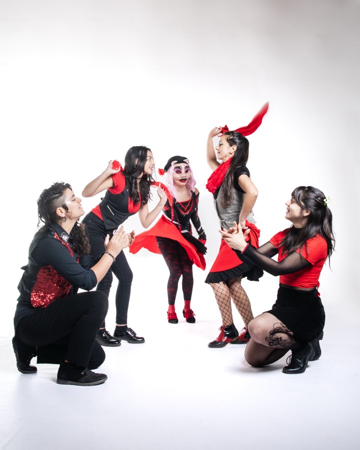 Las cinco integrantes de Banda La Inquieta, de rojo y negro, en una pose de baile.